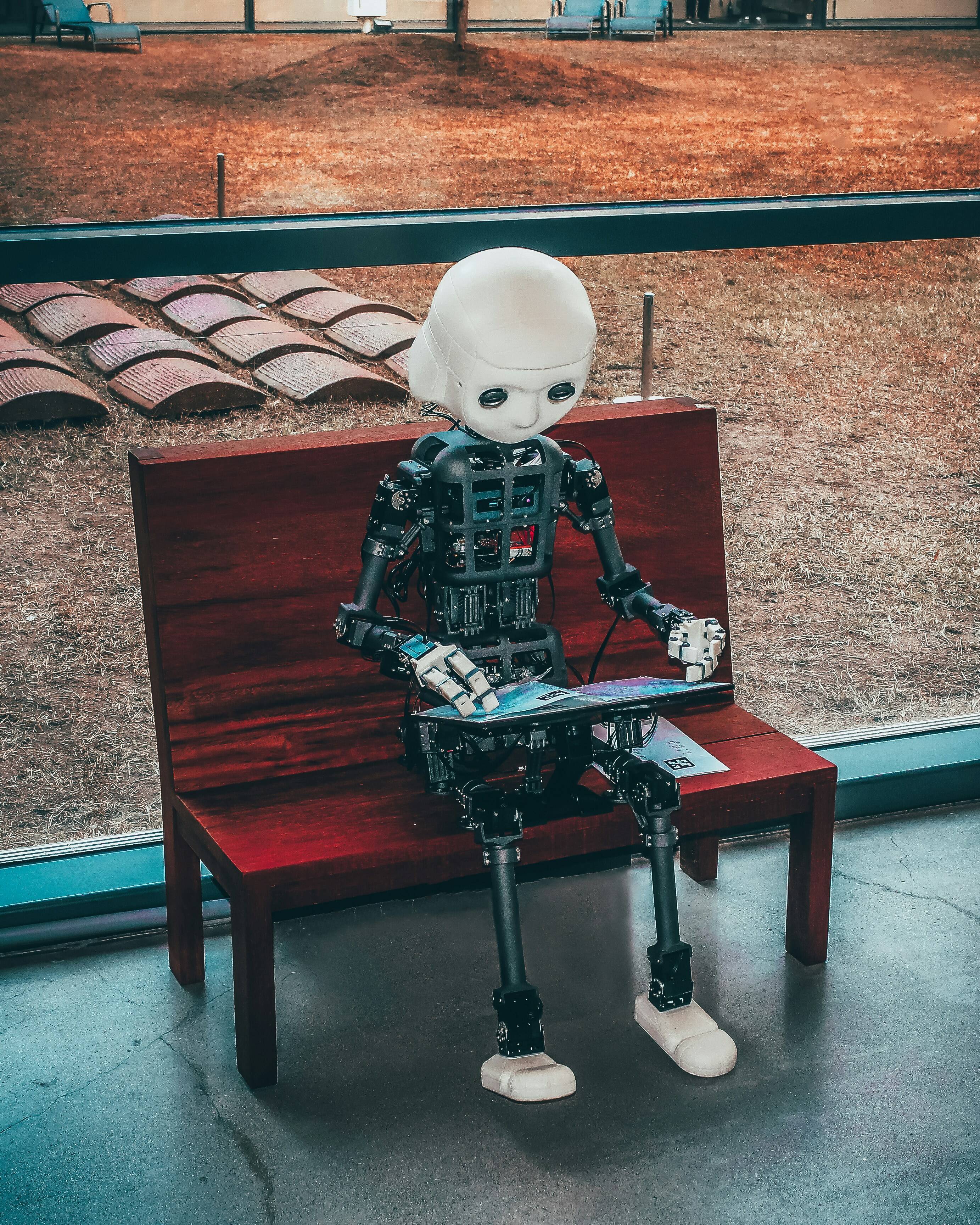 Robot child reading on a bench